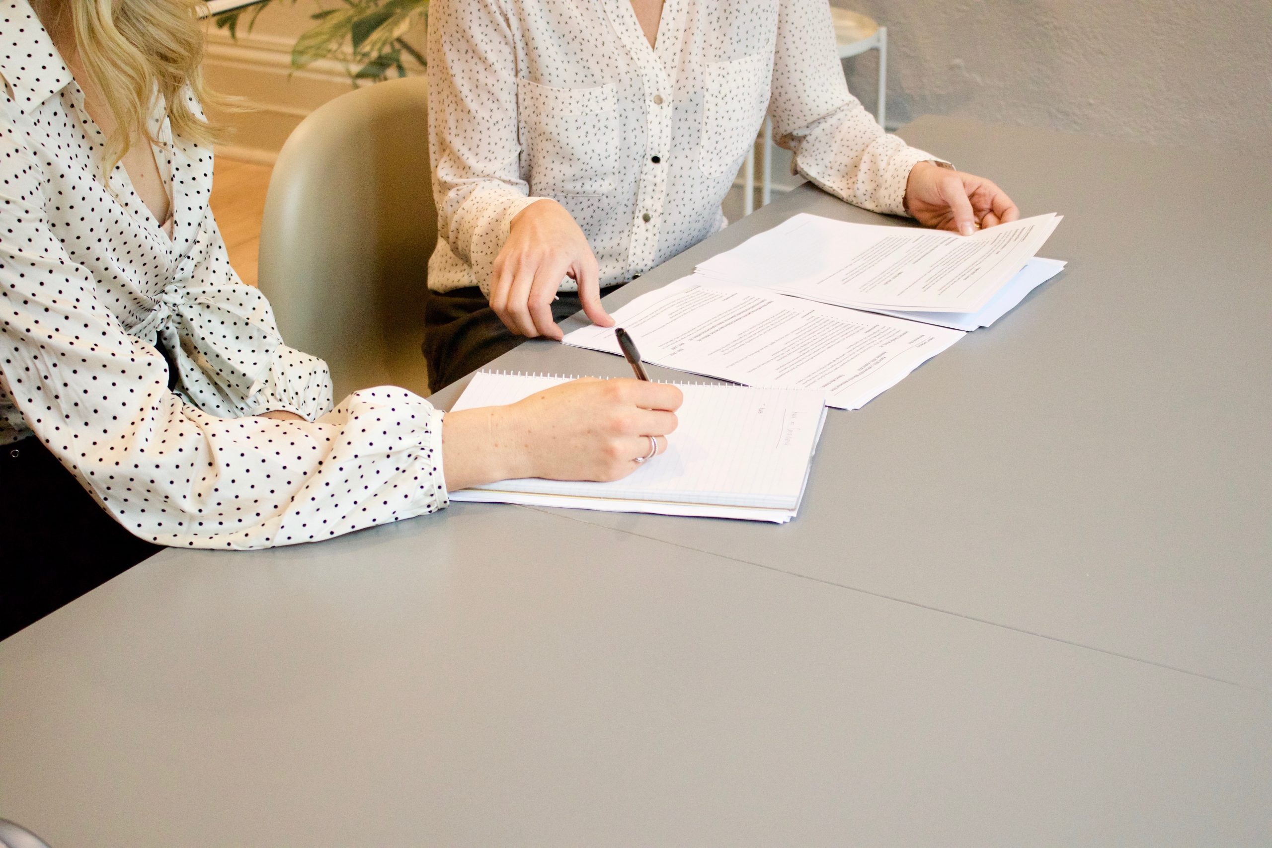 two women having a work meeting with documents