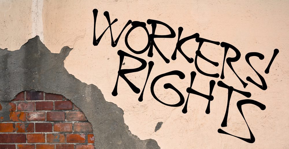 Workers rights graffiti on a wall
